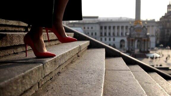 女人的腿走在城市的楼梯上