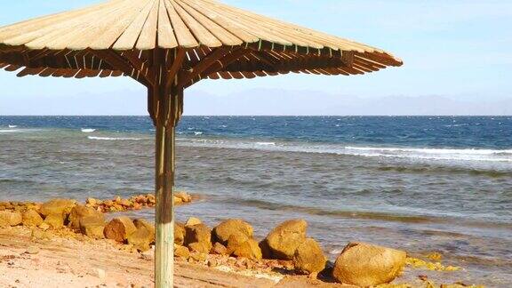 荒无人烟的海滩上的一把木制雨伞