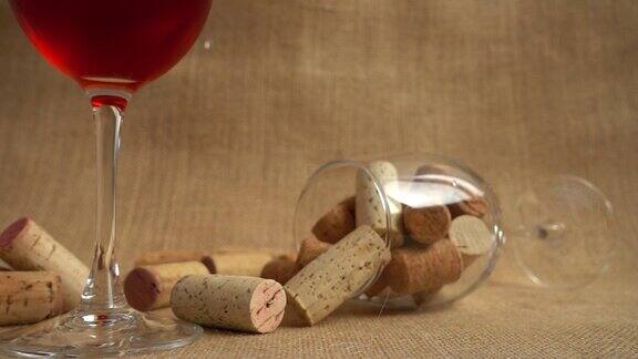 在玻璃杯和包的背景下葡萄酒软木塞落下缓慢的运动