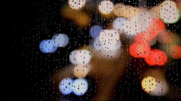城市夜晚的雨点落在窗户上