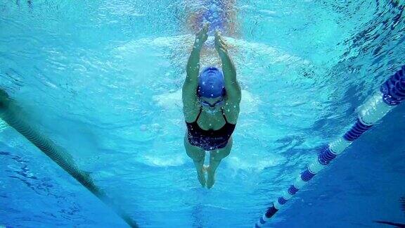 高清慢动作:年轻女子游泳蛙泳的水下镜头