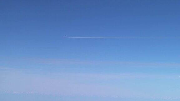 飞行中的飞机留下的白色痕迹飞机在蓝天白云间飞翔
