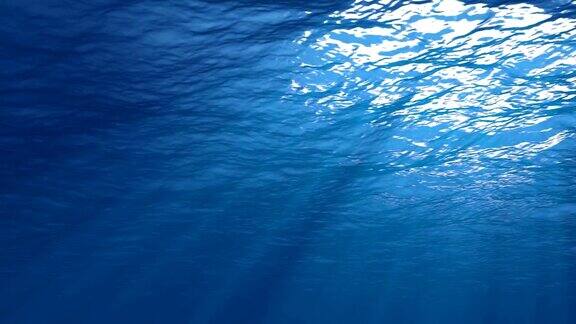 阳光从上面照射下来穿透深蓝色的海水形成美丽的水幕反射光线