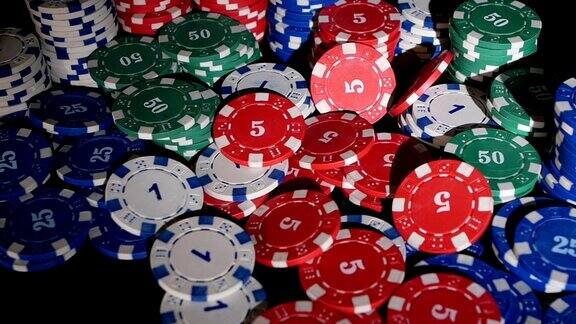 许多扑克筹码落在黑色背景上两个包
