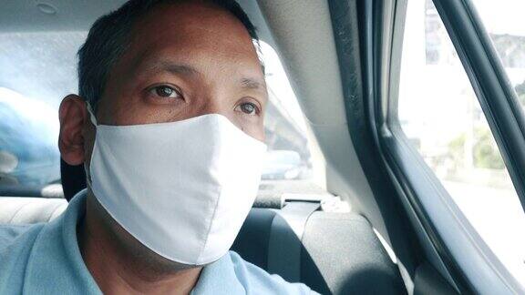 亚洲男子乘客在车内戴口罩