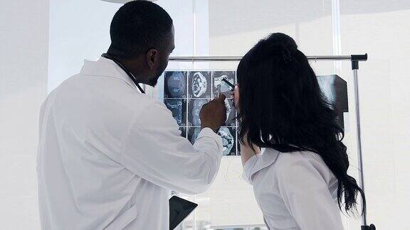 两名医生在医院讨论病人骨骼的x光指纹
