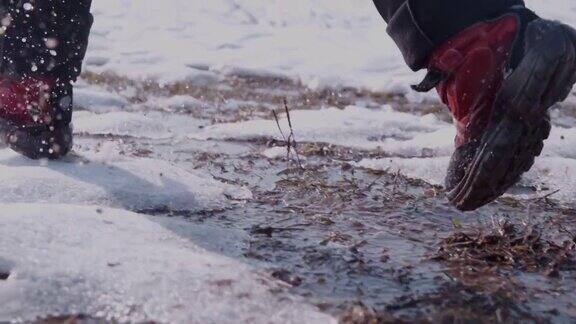 徒步者穿着靴子跑步在雪和水里溅水超级慢的动作