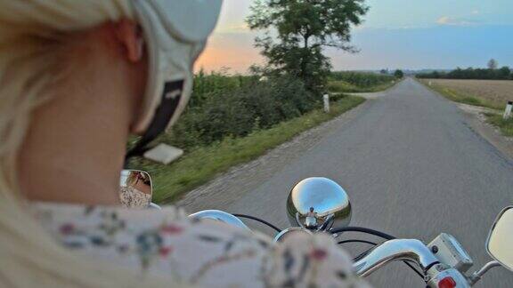 日落时分一名女子在乡间骑摩托车