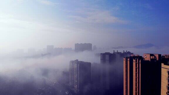 在城市中心浓雾上空的空中全景图日出