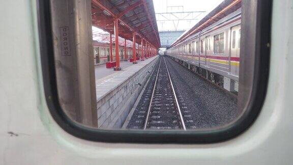 车窗看最后面的火车火车正驶离车站可以看到铁路、车站走廊等列车的左边