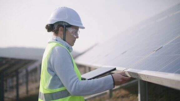 可再生能源系统太阳能电池板维护工程师在一个太阳能电站的现场工作