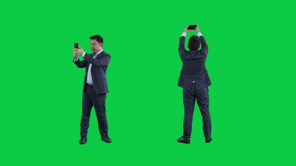 商人使用智能手机在绿色屏幕上4K镜头与阿尔法通道codeck-png+阿尔法