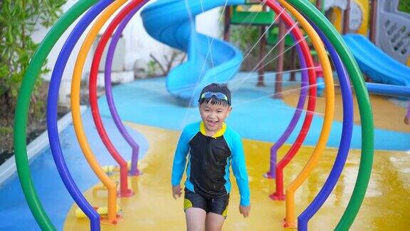 亚洲男孩在水上公园的水下玩耍和游泳