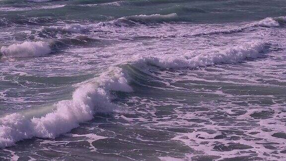 特写强烈的海浪和飞溅的碰撞和飞溅阳光明媚海面波涛汹涌巨大的海浪在希腊希俄斯的MegasLimnionas海滩上冲破岩石