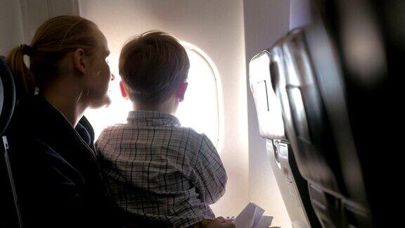 母亲和儿子在飞机上看灯