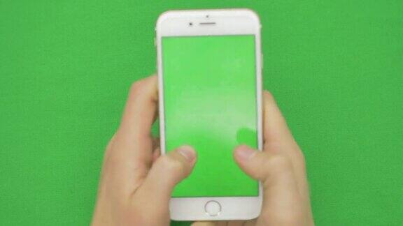 使用智能手机在绿色屏幕上用各种手势垂直、近距离显示绿色屏幕