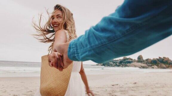 情侣手牵着手在海滩上散步