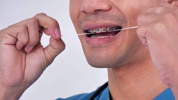 一位亚洲男医生会教你如何正确清洁和保养牙齿