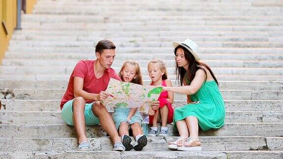 全家去欧洲度假家长和孩子用旅游地图搜索景点