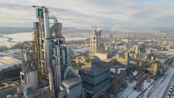 日落时分工业生产区的水泥厂鸟瞰图厂房结构高大塔式起重机