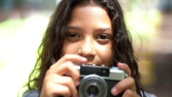 小女孩用复古相机拍照