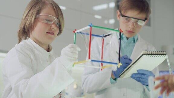 孩子们在实验室里做科学实验用肥皂泡液研究表面张力