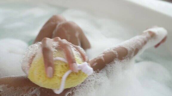 非洲裔美国妇女洗泡泡浴用淋浴海绵洗澡相机运动水疗中心