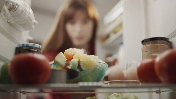 把一碗水果放进冰箱