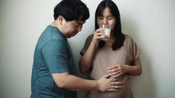 丈夫照顾他怀孕的亚洲妻子