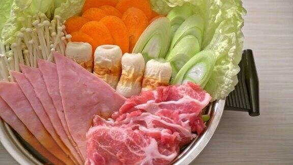 素喜烧或涮锅黑汤有肉、生的和蔬菜-日本料理风格