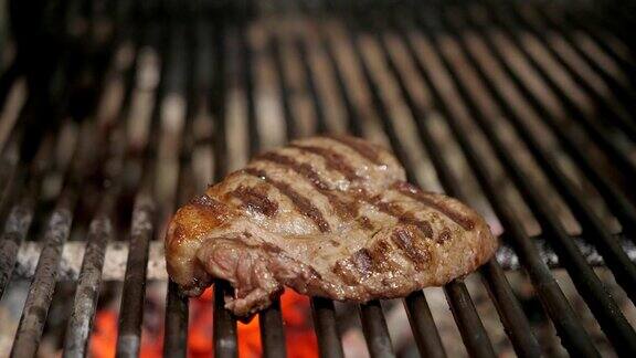烧烤时炸牛排典型的阿根廷烤肉在烤架上烧木头和烧红的煤