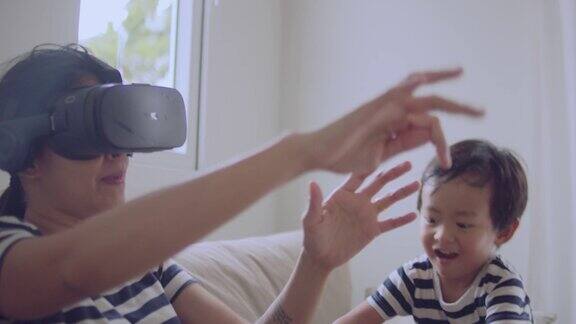 快乐的亚洲家庭与VR头盔探索虚拟现实-