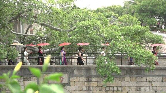一群打伞穿旗袍的女人
