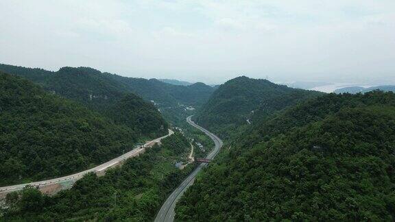 航拍大山中的高速公路高铁轨道